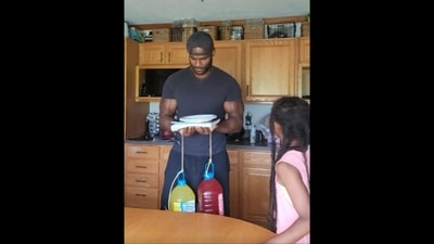 The image, taken from the Reddit video, shows little girl pulling off the hilarious weight challenge prank on her father. (Reddit/@DarthArrenKae) The image, taken from the Reddit video, shows little girl pulling off the hilarious weight challenge prank on her father. (Reddit/@DarthArrenKae)
