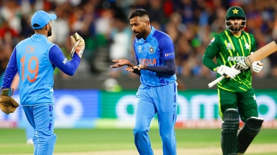India's Hardik Pandya and Dinesh Karthik celebrate the dismissal of Pakistan's Mohammad Nawaz during the ICC Men's T20 World Cup 2022 Super 12 Group 2 match between India and Pakistan, at Melbourne Cricket Ground, in Melbourne.(BCCI Twitter)