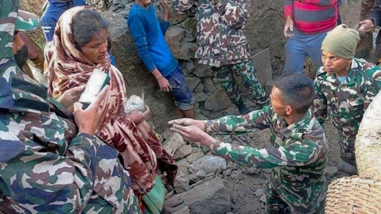 Members of the Nepal army work during a rescue operation at the ruins of a collapsed house, damaged after an earthquake struck early Wednesday, in the western district of Doti in Nepal.(PTI)