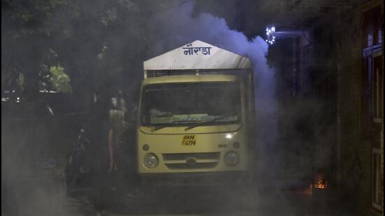 Health workers conduct a fumigation drive in Noida on Wednesday. (Sunil Ghosh/HT Photo)