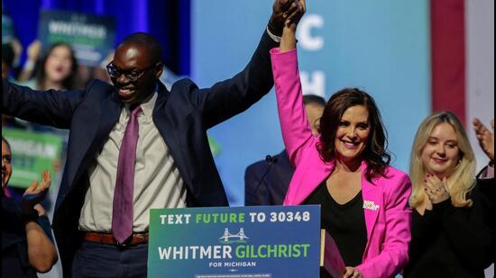 Democratic Michigan Governor Gretchen Whitmer (right) and Lieutenant Governor Garlin Gilchrist react during her 2022 US midterm elections night party in Detroit, Michigan. (REUTERS)