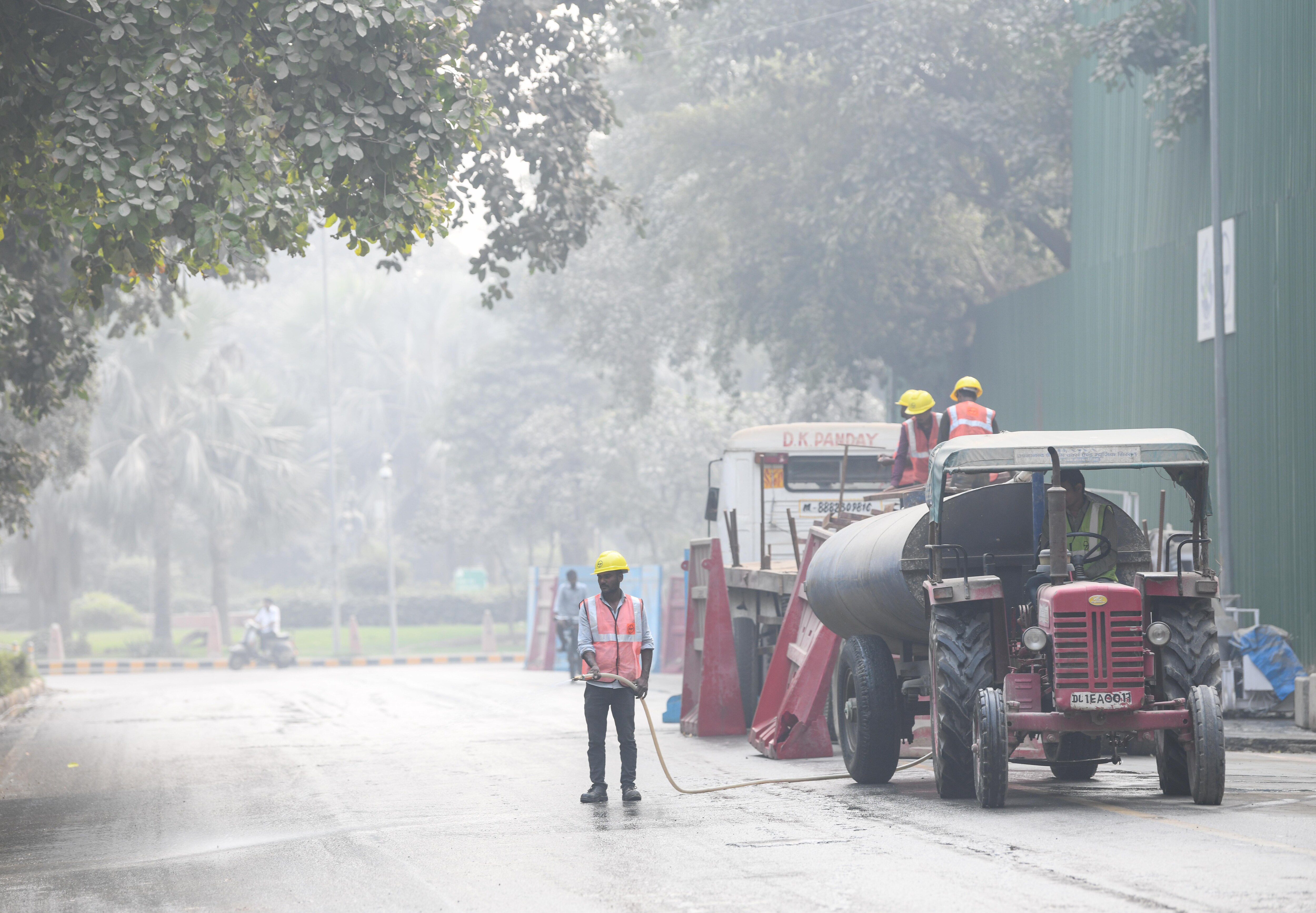 Public Works Department (PWD) workers use 'dust suppressants' sprinkling water to control road dust in view of rising air pollution, in New Delhi on Tuesday. (ANI Photo) (Amit Sharma) Public Works Department (PWD) workers use 'dust suppressants' sprinkling water to control road dust in view of rising air pollution, in New Delhi on Tuesday. (ANI Photo) (Amit Sharma)