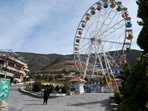 Afghanistan: Taliban guards standing next to a ferry wheel ride at the Habibullah Zazai Park.