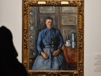 A visitor looks at Paul Cezanne's masterpiece Woman with a Coffee Pot displayed at the exhibition A visitor looks at Paul Cezanne's masterpiece Woman with a Coffee Pot displayed at the exhibition