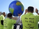 Demonstrators hold a globe during the COP27 U.N. Climate Summit, Thursday.(AP) Demonstrators hold a globe during the COP27 U.N. Climate Summit, Thursday.(AP)