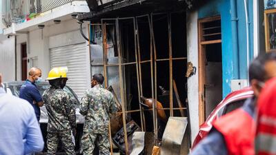 Firefighters and emergency personnel stand outside a building after a major fire swept through cramped living quarters of foreign workers in the Maldives capital Male on November 10, 2022. (AFP) Firefighters and emergency personnel stand outside a building after a major fire swept through cramped living quarters of foreign workers in the Maldives capital Male on November 10, 2022. (AFP)