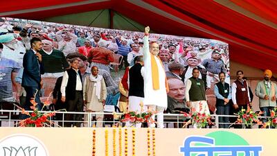 Union home minister Amit Shah greets BJP supporters during a public meeting for the upcoming Himachal Pradesh assembly elections, at Gurudwara Paonta Sahib, in Sirmour on Thursday. (Amit Shah/Twitter)