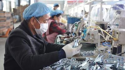 This file photo taken in October shows an employee working on an assembly line producing speakers at a factory in Fuyang city, in China's eastern Anhui province. Factory gate prices in China were down for the first time in nearly two years last month, official data showed on Wednesday, as falling global commodity prices made their mark on an economy ailing under strict Covid controls. (AFP) This file photo taken in October shows an employee working on an assembly line producing speakers at a factory in Fuyang city, in China's eastern Anhui province. Factory gate prices in China were down for the first time in nearly two years last month, official data showed on Wednesday, as falling global commodity prices made their mark on an economy ailing under strict Covid controls. (AFP)