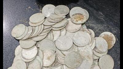 Workers engaged in digging came across a pot containing coins buried in the soil. (Sourced)