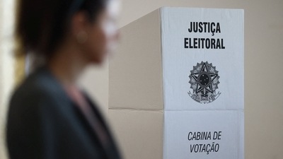 Brazil Elections: A Brazilian citizen passes by a voting booth for Brazil's election. (Reuters)