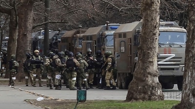 Russia-Ukraine War: Russian army soldiers stand next to their trucks during a rally against Russian occupation in Svobody . (AP) Russia-Ukraine War: Russian army soldiers stand next to their trucks during a rally against Russian occupation in Svobody . (AP)