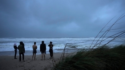 Hurricane Nicole: People brave rain and strong winds to visit Jensen Beach. (AP)