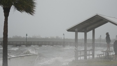 Hurricane Nicole: People brave rain and heavy winds to visit the waterfront along the Jensen Beach Causeway. (AP) Hurricane Nicole: People brave rain and heavy winds to visit the waterfront along the Jensen Beach Causeway. (AP)