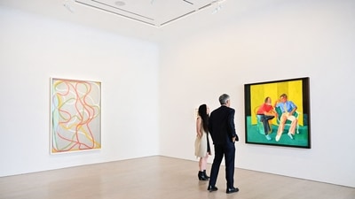 Christies senior specialist and senior vice president Alex Marshall (R) views 'The Conversation' by David Hockney. (AFP) Christies senior specialist and senior vice president Alex Marshall (R) views 'The Conversation' by David Hockney. (AFP)