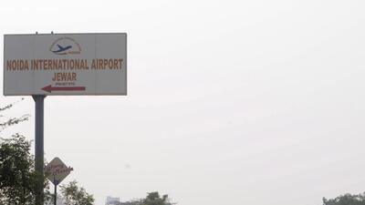 Greater Noida, India - December 17, 2020: A signboard points towards the Noida International Jewar Airport, in Greater Noida, India on Thursday, December 17, 2020. Uttar Pradesh Chief Minister Yogi Adityanath on Thursday gave his approval to the name and design of Jewar airport. The name was finalized during a meeting with the Swiss company- Zurich AG officials in Lucknow. (Photo by Sunil Ghosh / Hindustan Times) **To go with Vinod Rajput's story** Greater Noida, India - December 17, 2020: A signboard points towards the Noida International Jewar Airport, in Greater Noida, India on Thursday, December 17, 2020. Uttar Pradesh Chief Minister Yogi Adityanath on Thursday gave his approval to the name and design of Jewar airport. The name was finalized during a meeting with the Swiss company- Zurich AG officials in Lucknow. (Photo by Sunil Ghosh / Hindustan Times) **To go with Vinod Rajput's story**