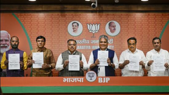 Union minister Bhupendra Yadav releasing the list of BJP candidates. (PTI)