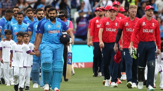 The Indian and England cricket team walk ahead of their semifinal encounter at the T20 World Cup(AFP)