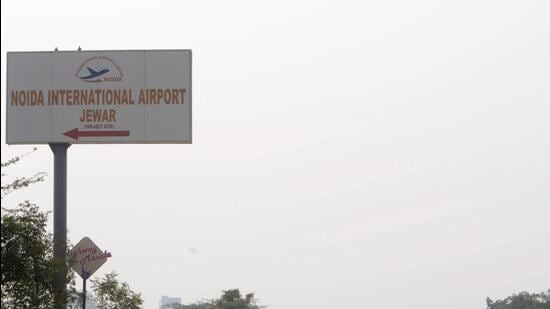 Greater Noida, India - December 17, 2020: A signboard points towards the Noida International Jewar Airport, in Greater Noida, India on Thursday, December 17, 2020. Uttar Pradesh Chief Minister Yogi Adityanath on Thursday gave his approval to the name and design of Jewar airport. The name was finalized during a meeting with the Swiss company- Zurich AG officials in Lucknow. (Photo by Sunil Ghosh / Hindustan Times) **To go with Vinod Rajput's story**