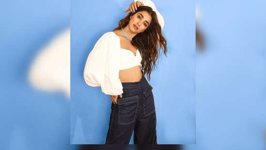 In the pictures shared by Pooja Hegde on her Instagram handle, the actor can be seen wearing a white crop top and flared pants.(Instagram/@hegdepooja)