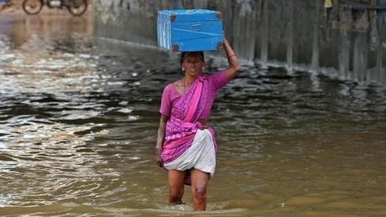 A woman wades through a water-logged subway during Chennai rains. (File)(REUTERS)