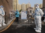 Workers in protective gear at a neighborhood placed under lockdown due to Covid-19 in Beijing, China, November 10.(Bloomberg) Workers in protective gear at a neighborhood placed under lockdown due to Covid-19 in Beijing, China, November 10.(Bloomberg)