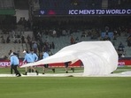 File photo of groundstaff trying to cover the MCG pitch during a T20 World Cup match(AP) File photo of groundstaff trying to cover the MCG pitch during a T20 World Cup match(AP)