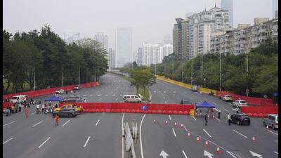 Barriers form a security checkpoint in the Haizhu district in Guangzhou in southern China's Guangdong province on Friday. As the country reported more than 10,000 new Covid cases on Friday, more than 5 million people were under lockdown in the southern manufacturing hub Guangzhou and the western megacity Chongqing. (AP)