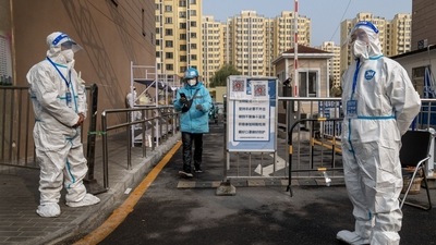 Workers in protective gear at a neighborhood placed under lockdown due to Covid-19 in Beijing, China, November 10. (Bloomberg) Workers in protective gear at a neighborhood placed under lockdown due to Covid-19 in Beijing, China, November 10. (Bloomberg)