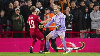 Liverpool goalkeeper Caoimhin Kelleher, right, celebrates with teammate Harvey Elliott after the English League Cup soccer match between Liverpool and Derby County, at Anfield Stadium, in Liverpool (AP)