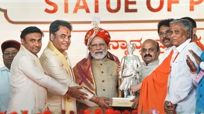 Prime Minister Narendra Modi being presented a memento during a public meeting in Bengaluru after the inauguration of Terminal 2 of the KIA. (PTI)
