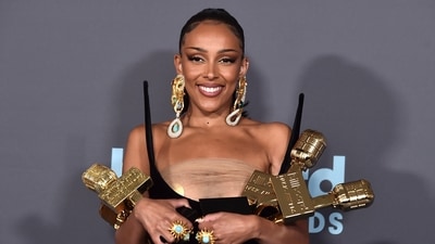 Doja Cat poses in the press room with the awards for top R&B artist. (Jordan Strauss/Invision/AP)