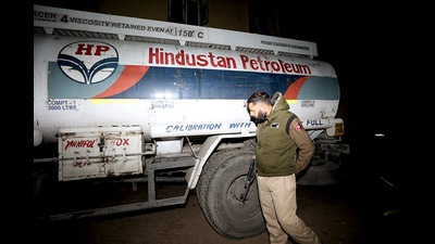 Jammu and Kashmir police inspect an oil tanker for arms and ammunition after busting a Jaish-e-Mohammed (JeM) module along with the arrest of three accused from the Narwal area, in Jammu on Thursday. Huge cache of arms and ammunition were recovered from their possession. (ANI)