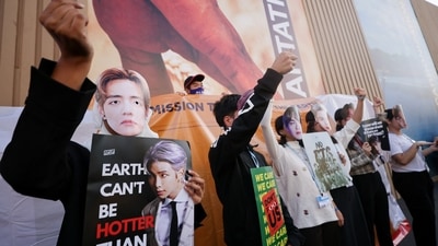 Climate activists of the BTS army protest against climate change at the Sharm El-Sheikh International Convention Centre, during the COP27 climate summit, in Sharm el-Sheikh, Egypt, Thursday. (REUTERS)