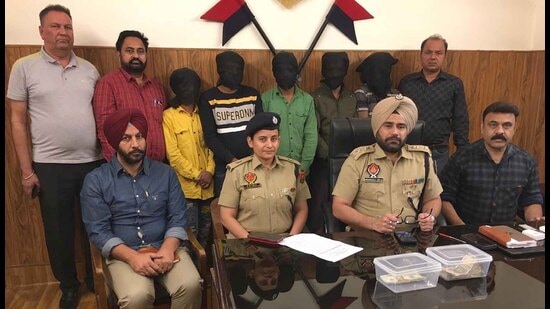 The accused and currency recovered from them in Ludhiana police custody.