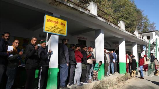 Voters waiting for their turn to cast their vote at a polling station in Kullu in Himachal Pradesh on Saturday. (Aqil Khan/HT)