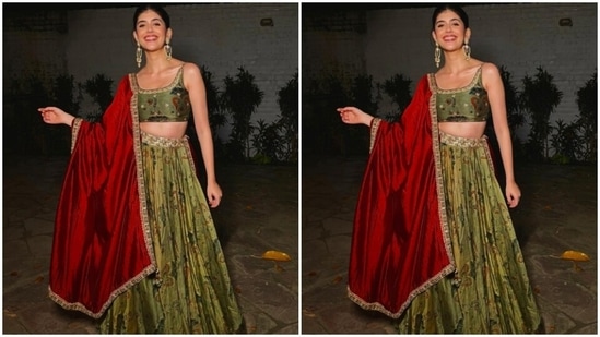 Sanjana's green lehenga came with multicoloured patterns and golden zari details at the borders. She teamed it with a contrasting bright red dupatta and stole the limelight. (Instagram/@sanjanasanghi96)