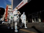 Pandemic prevention workers in protective suits walk near an apartment compound that was placed under lockdown as outbreaks of the coronavirus disease (Covid-19) continue in Beijing. China tightens travel restrictions as rise in coronavirus cases reported 