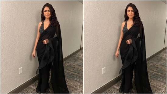 Mrunal teamed the saree with a matching black blouse with silver sari details and a diamond neck choker. (Instagram/@mrunalthakur)