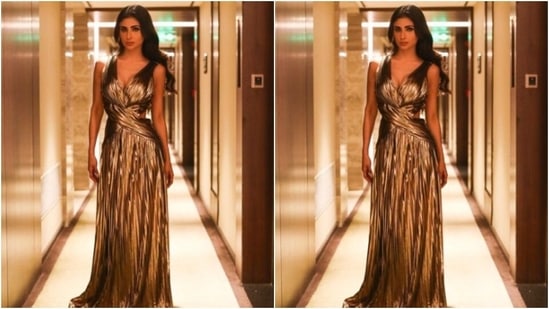 Mouni decked up in a golden metallic gown featuring sleeveless patterns with wrap around fabric details. It also came with a plunging neckline, cut out details at the sides and frill details below the waist. (Instagram/@imouniroy)