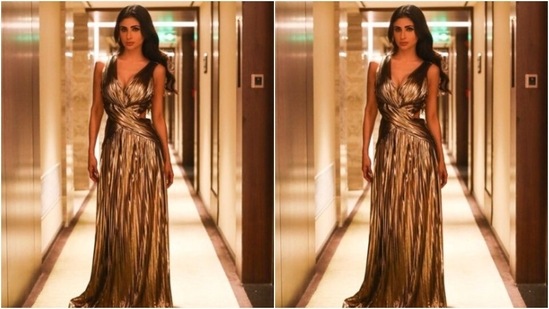 Mouni decked up in a golden metallic gown featuring sleeveless patterns with wrap around fabric details. It also came with a plunging neckline, cut out details at the sides and frill details below the waist. (Instagram/@imouniroy)