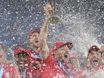 England's captain Jos Buttler, center, holds the trophy as players spray champagne while they celebrate after defeating Pakistan in the final (AP) England's captain Jos Buttler, center, holds the trophy as players spray champagne while they celebrate after defeating Pakistan in the final (AP)