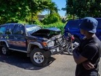 A person looks at the vehicle of Eric Jean-Baptiste, former presidential candidate and leader of the Rally of Progressive National Democrats, as it sits near the police station in P�tion-ville, Haiti, on November 14, 2022.(AFP)