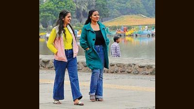Residents increase layers to their clothing amid a temperature dip on Monday. (Keshav Singh/HT)