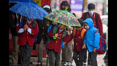 School children hold umbrellas as they walk along a street amid rainfall in Srinagar on Monday. (AFP) School children hold umbrellas as they walk along a street amid rainfall in Srinagar on Monday. (AFP)