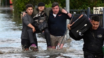 Australia Floods: A woman is rescued from floodwater in Melbourne, Australia's suburb of Maribyrnong. (AP) Australia Floods: A woman is rescued from floodwater in Melbourne, Australia's suburb of Maribyrnong. (AP)