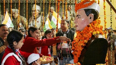 Students from a school in Dehradun pay floral tribute to India's first prime minister Jawaharlal Nehru on his birth anniversary. (PTI)