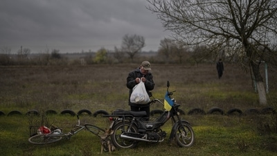 Russia-Ukraine War: A resident collects a food donation in Novokyivka, southern Ukraine. (AP) Russia-Ukraine War: A resident collects a food donation in Novokyivka, southern Ukraine. (AP)