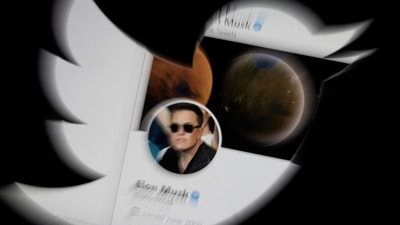 FILE PHOTO: Elon Musk twitter account is seen through Twitter logo in this illustration taken, (REUTERS)