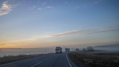 This photograph taken on November 14, 2022, shows a foggy morning road between newly liberated Kherson and Mykolaiv in Ukraine. (AFP)