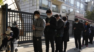 Covid In China: Residents line up outside a community for Covid test in Beijing. (AP) Covid In China: Residents line up outside a community for Covid test in Beijing. (AP)